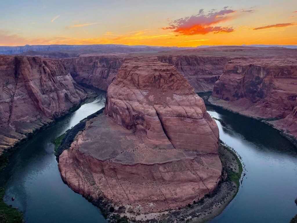 Sunset view of Horseshoe Bend Arizona with warm light over the canyon and Colorado River